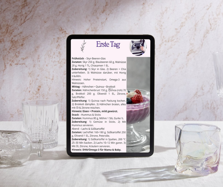 Tablet mit Celestro MamaFit+ – Ernährungsplan „Erster Tag“ auf Marmor, daneben Joghurtglas; stillfreundliche Rezepte für Frühstück, Mittag, Snack & Abend.
